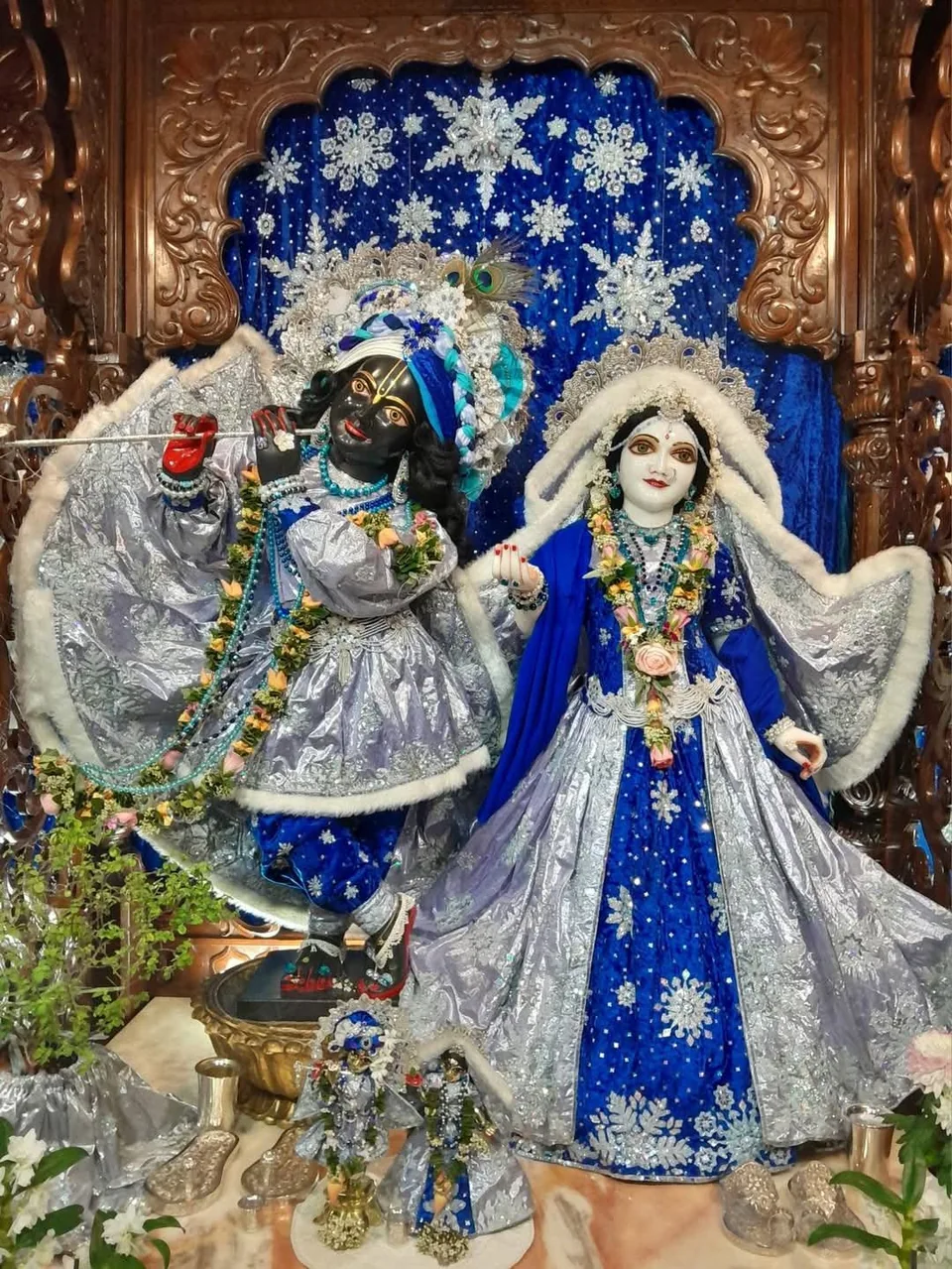 Deities adorned in blue and silver attire