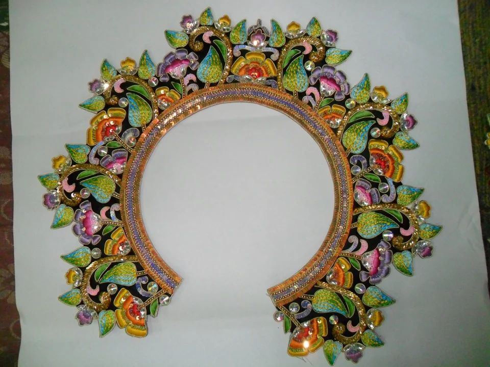 Multicolour floral accessory with a circular central opening laid on a pale surface