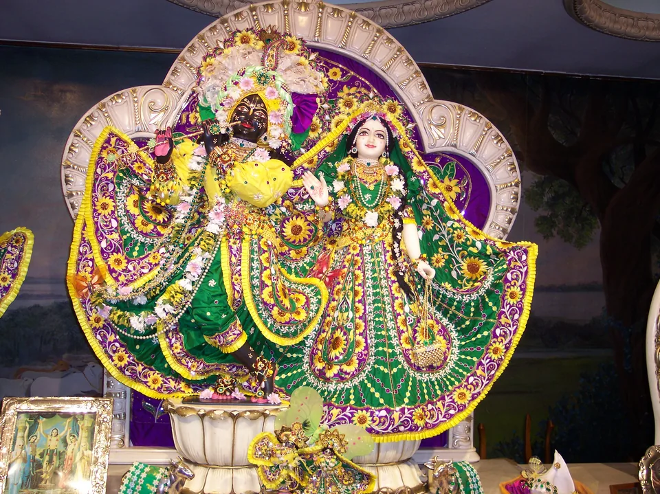 Radha Krishna in green attire with purple edging and colourful decorative motifs
