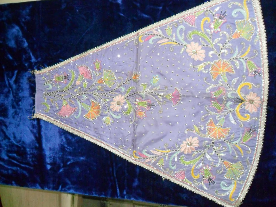 Lavender shaped panel with multicolour flowers and pale decorative edges on a blue surface