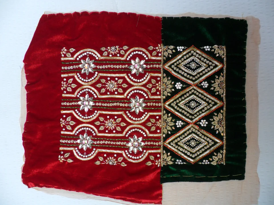 Red and dark fabric samples with repeated pale floral bands and outlined diamond motifs