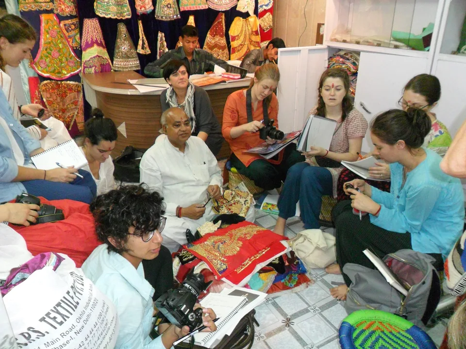 Visitors exploring embroidered deity attire at the Ashok Mukut Wala shop in Vrindavan